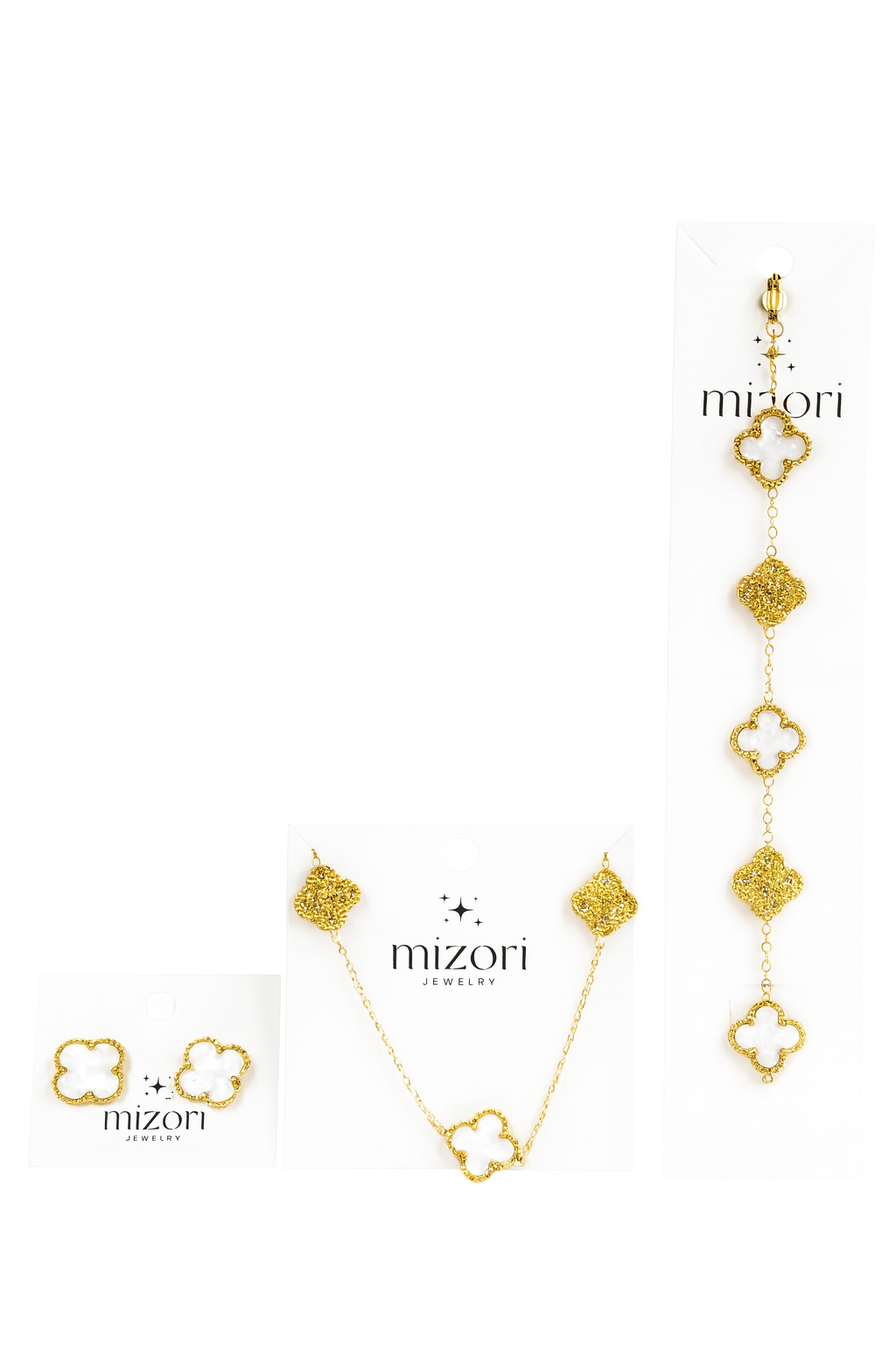 Mizori Jewelry stainless steel gold set with 13mm white clover necklace, bracelet, and earrings accented with sparkling stones, water resistant.